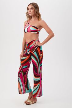 TRINA TURK SWIMWEAR A tropical pattern adds a vacation feel to these swim cover-up pants with a front sash tie and loose, relaxed fit for a breezy feel. Pair these colorful swim cover-up pants with our matching swimsuit for beach-ready style. Elastic waist Adjustable sash ties at the waist Wide leg Full-length inseam Loose, relaxed fit Sheer fabrication Runs small; see SIZE CHART Model is 5'10", wearing size S FABRIC: Swoop Mesh Knit 88% Nylon, 12% Spandex Hand wash cold Imported Shop the entire Knot Top, Two Piece Swimwear, Knot Design, Beach Pants, Beach Ready, Tops And Bottoms, Tropical Pattern, Swim Cover, Trina Turk