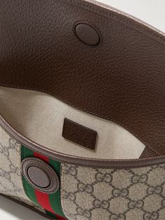 Gucci's 'Ophidia' belt bag has been crafted in Italy from monogrammed coated-canvas in classic shades of brown. Detailed with a gold emblem, it's trimmed with durable full-grain leather and signature striped webbing. Luxury Belt Bag Pouch, Luxury Pouch-shaped Belt Bag, Designer Pouch Belt Bag With Detachable Strap, Designer Monogram Canvas Crossbody Belt Bag, Brown Leather Gucci Belt Bag, Gucci Brown Leather Belt Bag, Classic Monogram Canvas Belt Bag With Removable Pouch, Classic Monogram Canvas Belt Bag For Everyday, Luxury Beige Leather Belt Bag