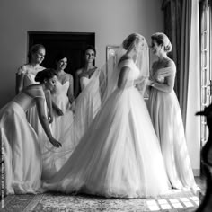 the bride and her bridesmaids are getting ready for their wedding