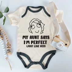 Celebrate the special bond between aunt and baby with this adorable 'My Aunt Says I'm Perfect' custom baby bodysuit! Perfect for nieces or nephews, this funny and cute outfit is ideal for pregnancy announcements, birth reveals, or baby showers. Made from soft, high-quality fabric, this unisex bodysuit is comfortable and stylish, featuring a playful saying that’s sure to bring a smile to Auntie's face. Whether it's a gift for a new baby or a fun way to announce 'coming soon,' this bodysuit is a must-have for every family. Available in multiple sizes and perfect for any occasion, it's a delightful way to celebrate the love and humor shared between an aunt and her little one! This baby bodysuit is machine washable, making it easy to care for. The romper is super soft and easy to wear and take Aunt Onsies, Birthday Baby Announcement, Pregnancy Announcement Aunt, Birth Reveal, Birth Plans, Aunt Quotes, Cute Pregnancy Announcement, Funny Pregnancy Announcement, Pregnancy Announcements