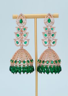 "Statement CZ Long Jhumki Earrings | Rose Gold Emerald Diamond Jhumki|Indian Jewelry |Pakistani Jewelry | Jhumkas | American Diamond Earrings A premium quality statement CZ long jhumki earrings with Monalisa Stone and Beads tassels. Add a pop of color with this trendy long Jhumki for a touch of sparkle in your festive looks. Length: Approx. 3\" Weight of each earring: 21 gms Push-Back closure  Finish: Rose Gold Polish High-quality brass as the base metal. Availability: In-Stock. *Color may vary slightly due to light condition & photography. Jewelry Care:  Keep away from moisture. Allow perfumes and lotion to dry before wearing. Store in jewelry pouch. Clean only with soft lint-free cloth." Luxury Green Chandbali Jhumkas, Luxury Green Jhumkas For Diwali, Luxury Green Jhumkas For Festivals, American Diamond Earrings, Beads Tassels, Photography Jewelry, Jewelry Pakistani, Jhumki Earrings, Earrings Rose Gold