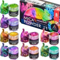 12 different colors of acrylic powder in front of a box