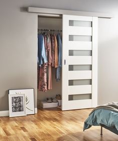 an open closet with clothes hanging in it