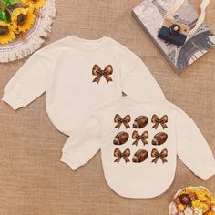 Coquette Football Game Day Romper Sweatshirt, Halloween Sports Baby Outfit, Cute Toddler Pullover, Fall Baby Girl Gift, Cozy Romper ⭐ Product Description: * Handmade with Care: Each romper is handcrafted with attention to detail. * Ships from the USA: Quick and reliable shipping from our U.S.-based workshop. * High-Quality Materials: Made from 100% CPSIA Compliant and ethically sourced fabric. The light fabric (5.0 oz/yd² or 170 g/m²) ensures comfort and durability. * Soft and Breathable: Crafte Playful White Sweatshirt For Fall, Long Sleeve Fall Birthday Sweatshirt, Family Matching Long Sleeve Tops With Cartoon Print, Long Sleeve Tops With Cartoon Print For Birthday, Family Matching White Long Sleeve Sweatshirt, White Long Sleeve Sweatshirt For Family Matching, White Long Sleeve Family Matching Sweatshirt, Fall Playtime Crew Neck Tops, Graphic Print Sweatshirt For Playtime In Fall