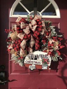 a red door with a christmas wreath on it