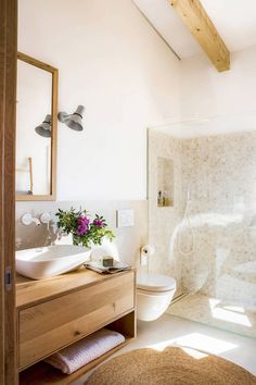 a bathroom with a sink, toilet and shower stall in it's own area