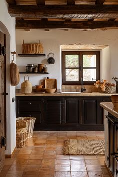 a kitchen with wooden cabinets and tile flooring next to an open door that leads to the outside