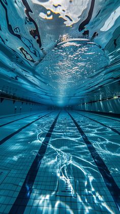 an underwater swimming pool with blue tiles and water