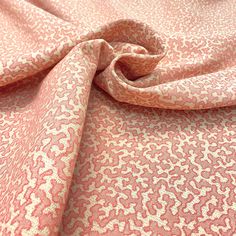 a pink and white fabric with an animal print pattern on the bottom half of it