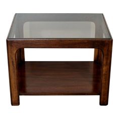 a wooden table with glass top and shelf on the bottom, against a white background