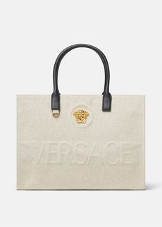 Crafted from canvas, this tote bag is adorned with a central La Medusa plaque and tonal debossed Versace logo lettering. The contrasting top handles are crafted from leather, and the spacious interior has two zipped pockets and a protector strap. Canvas Tote Bag Outfit, Bag Versace, Tote Bag Outfit, Versace Bag, Versace Logo, Bag Outfit, Versace Bags, Purse Styles, Lady Dior Bag