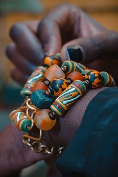 The hand painted krobo beads are famous for their intrigueing color combinations.We created this beautiful bracelet with antique Turquoise Hebron beads,recycled Gas beads and ceramic Krobo beads. This bracelet is 7.5 inches long with extra links to allow for adjustment.Its width spans to almost 2 inches and is light on the wrist. We use art as a vehicle to create sustainable income for the young women we work with. Thank you for visiting our store! Xoxoxo Atiamuga Chunky Bracelets Bohemian, Luxury Multicolor Wooden Beads Jewelry, Cheap Orange Bohemian Beaded Bracelets, Cheap Orange Bohemian Stretch Bracelet, Affordable Large Beads Hippie Jewelry, Luxury Multicolor Jewelry With Wooden Beads, Affordable Statement Jewelry With Wooden Beads, Cheap Handmade Statement Stretch Bracelet, Affordable Bohemian Wooden Beads Stretch Bracelet