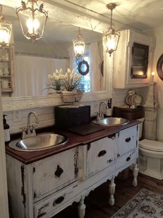 a bathroom with two sinks and a toilet