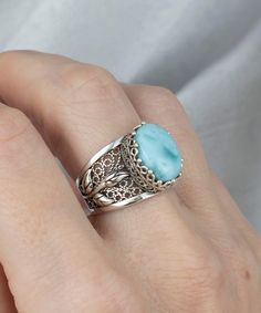 Look beautiful and feel blessed with our Filigree Art Larimar Gemstone Tulip Detailed Silver Women Statement Ring, crafted out of 925 Sterling Silver. With its handmade filigree art and stunning larimar gemstone, this ring is sure to bring luck and joy to whoever wears it! Make a statement with this breathtakingly elegant ring. This 925 Sterling Silver Women Cocktail Ring is the perfect gift for her. With its Filigree Art Tulip Detailed Gift Ring design and natural Larimar Gemstone, it's perfect Elegant Blue Larimar Turquoise Ring, Larimar Gemstone Jewelry For Wedding, Elegant Larimar Rings For Anniversary, Elegant Turquoise Ring With Natural Stones, Elegant Oval Larimar Rings, Wedding Larimar Gemstone Rings, Elegant Handmade Turquoise Wedding Ring, Elegant Turquoise Larimar Ring As Gift, The Ring Face