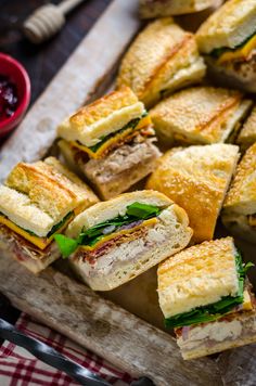 several sandwiches cut in half on a cutting board