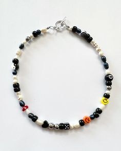 "Necklace beaded by me with luuvvvv <3 Will look very similar to photos. Has all different sizes of black and white freshwater pearls, that will vary due to natural variation. Circle toggle clasp closure, all necklace will have orange & yellow smiley face, red mushroom, 8ball, yin yang and dice.  Necklace in photos is 18\"." Trendy Black Necklace With Colorful Beads, Casual Black Jewelry With Heart Beads, Black Bohemian Letter Beads, Black Letter Round Beads, Bohemian Black Letter Beads, Trendy Black Beaded Necklace, Fun Black Beaded Bracelets With Round Beads, Black Beaded Necklace With Letter Beads, Black Necklaces With Colorful Beads For Festivals