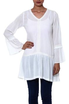 Crafted of silky viscose in a romantic ruffled style this semi-sheer tunic by Indiaâs Sandip Agarwal is perfect for welcoming the warming springtime sun. Features diamond-shaped motifs along the neck and bodice with 3/4-length bell sleeves and ruffled peplum. V-neck Blouse With Ruffle Hem For Vacation, Flowy V-neck Rayon Peasant Top, Viscose Long Sleeve Blouse For Layering, Long Sleeve Viscose Blouse For Layering, Bohemian Long Sleeve Tops With Ruffle Hem, Spring Stretch Viscose Blouse, Casual Ruffled Viscose Blouse, Bohemian Billowy Blouse For Beach, Flowy Tunic Peasant Top For Fall