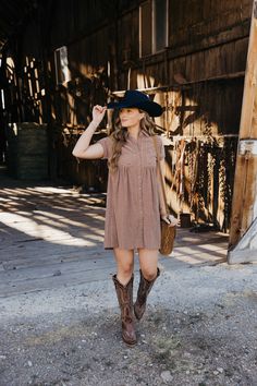 Introducing The Zuri Dress, a playful knee-length western dress in a gorgeous rust color. Made from textured fabric, this dress features a flattering fit and flare silhouette with short sleeves and a v neckline. Complete with a collared button down design and pocket detail, it's the perfect dress for fall fun! Haylee is wearing size small paired with the Ariat Casanova Boots, Felt Cowboy ProHat and The Talia Bag Zuri Dress, Dress For Fall, Western Dress, Curvy Dress, Heritage Collection, Western Dresses, Rust Color, Textured Fabric, Fall Fun