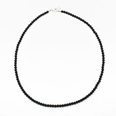 Black Onyx beads are hand strung to form this classic single strand necklace. The beads are tiny measuring about 3.0mm. This is a beautifully tiny, and delicate onyx necklace. You could wear this alone or stack with other necklaces for a layering effect.• 3mm round black Onyx beads• 925 Sterling silver or 14/20 Gold Filled lobster clasp and ring• Available in 14" to 42" lengthsI have hand strung these beads using a premium beading wire that has beautiful drape and it fastens with a sterling silv Black Beaded Necklace, Black Onyx Jewelry, Black Onyx Necklace, Black Beaded Jewelry, Onyx Jewelry, Black Bead Necklace, Gemstone Beaded Necklace, Onyx Necklace, Onyx Bracelet