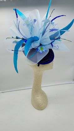 Beautiful multi blue color Fascinator with feathers and flowers. Style to go with a variety of outfits: bridesmaids, cocktail party, Kentucky Derby, Rehearsal dinner, Easter and church outfits. Ones with hair clip and headband. Are you trying to match an outfit? Send a picture and I will help you find a best hat to match your outfit. - Rare find - Ready to ship - Lightweight - Free Shipping - Fast shipping - Customize by adding different color flowers and or feathers Check my store for for style Blue Costume Hats And Headpieces For Spring Evenings, Summer Blue Headpiece With Handmade Flowers, Blue Headpieces For Spring Weddings, Spring Blue Mini Hats With Handmade Flowers, Blue Fascinator For Royal Ascot Garden Party, Blue Fascinator For Kentucky Derby Garden Party, Blue Hats With Handmade Flowers For Royal Ascot, Blue Fascinator With Handmade Flowers For Kentucky Derby, Blue Fascinator For Garden Party And Royal Ascot