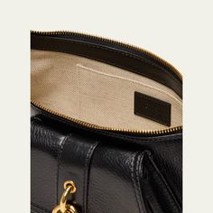 Chloe "The 99" shoulder bag in shiny-grained calfskin leather  Shoulder strap  Zip top closure  Exterior, two zip pockets and one flap pocket  Interior, one slip pocket  Lining: Cotton/linen Approx. 5.1"H x 14.1"W x 3.9"D Made in Italy Luxury Saddle Bag With Gold-tone Hardware For Travel, Luxury Everyday Saddle Bag, Designer Pebbled Leather Shoulder Bag For Travel, Designer Saddle Bag With Gold-tone Hardware For Business, Luxury Pebbled Leather Bag With Adjustable Strap, Designer Pebbled Leather Shoulder Bag With Leather Lining, Luxury Saddle Bag With Gold-tone Hardware For Everyday, Luxury Textured Leather Saddle Bag, Luxury Business Saddle Bag With Gold-tone Hardware