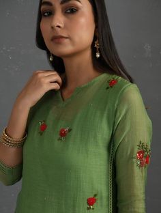 A straight-cut kurta in cotton silk fabric with all-over floral buttis made using A straight-cut kurta in cotton silk fabric with all-over floral buttis made using beads, sequins and silk French knots. Kurta, pants and dupatta have a lace edging at the hem, side cut, and sleeve ends. Bead work runs along the neckline and in between lace patterns. Delicate pin tucks stitched across the organza dupatta with embroidered scalloped edges and machine stitches in between pin tucks. Elasticated waist co Knots Hairstyle, French Knot Hairstyle, Yoke Embroidery, Machine Stitches, Kurti Sleeves, Kurta Pants, Knot Embroidery, Embroidery Kurti, Kurti Sleeves Design