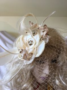 Fascinator Hat, Off-White Flower Bead Center, Vintage Beige Flowers, Vintage Curled & Goose Biot Feathers. Beige Bird Cage Veil, Hair Clip. This fascinator is fun to add to your hairdo for any special occasion or just to dress up your look. Great Wedding or Bridal Hair Decoration. Wear in your hair or on a hat for a glamorous touch. Clips Into Hair. Wear the Veil to the front or to the back. For other vintage and homemade items see: www.VeryVictorianStudio.etsy.com For sewing related items s Handmade White Mini Hats For Wedding, Handmade Cream Hats For Wedding, Handmade White Wedding Costume Hats And Headpieces, White Handmade Wedding Costume Hats And Headpieces, Handmade Adjustable Mini Hat For Weddings, Handmade Flower Headpiece For Wedding, Handmade Mini Headband Hats For Wedding, Handmade Mini Hat Headband For Wedding, Adjustable Handmade Flower Headpiece For Church