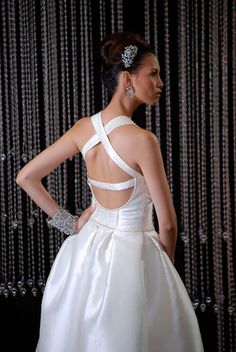 a woman in a white dress is standing with her back to the camera