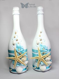 two white bottles decorated with shells and starfish