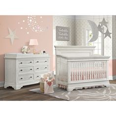 a baby's room with pink walls, white furniture and stars on the wall