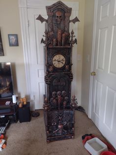 a tall wooden grandfather clock sitting on top of a carpeted floor next to a doorway