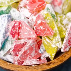 a wooden bowl filled with colorful gummy bears