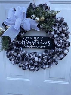 a black and white christmas wreath on a door