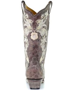 a pair of cowboy boots with flowers on the inside, and an embellishment in the back