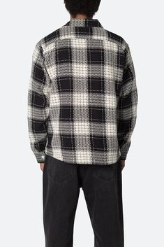 the Classic Flannel Shirt is designed with a standard fit, a flat hemline, pleats at the wrist with an adjustable button closure, slits at the side seam, all in a cotton plaid woven fabric. details standard fit 100% cotton model is 6’0, 160 lbs and wears a size medium note: for a more relaxed fit we recommend sizing up one size from your standard mnml size Classic Black Flannel Top, Classic Winter Plaid Top, Black Flannel Shirt With Button Closure, Layered Hoodie, Stock Tie, Sherpa Pullover, Fall Layers, Denim Flares, Fabric Details