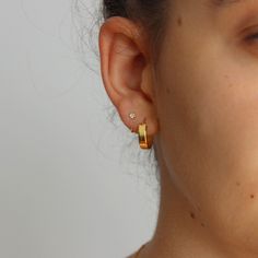 These dainty sterling silver Huggies / open style hoops feature a bezel set crystal, they are tiny and are absolutely gorgeous on. They look fabulous worn solo or with multiple piercings. Great for first, second or third hole piercings.  Open hoop / huggies are easy to put on - simply slide in and keep turning until the end is flush with the front of the lobe. Great huggies for everyday and perfect for multiple piercings 💖 Details 925 Sterling Silver & Gold Plating Diameter: 10 mm Width: 3 mm Online store: www.thejewellerytree.net 💕 Stay up-to-date with new designs & special offers  - FOLLOW ME   Socials: @myjewellerytree OR  https://www.facebook.com/thejewellerytree1/  💕 Need more info, feel free to email - I'd love to help 💕And please visit my store https://www.etsy.com/au/shop/TheJe Silver Huggies, Multiple Piercings, Earring Gold, Jewelry Tree, Gold Earring, Huggie Earrings, Fabric Bag, Jewelry Earrings Hoops, Gold Plated Silver