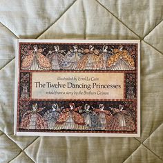 the twelve dancing princesses book is laying on a bed