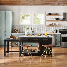 a kitchen with wooden floors and blue cabinets