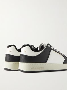 SAINT LAURENT's 'SL/61' style is a great way to up your sneaker game, while maintaining a classic look. They have panelled leather uppers with perforated toe boxes and are stamped with gold lettering across the back and sides. Saint Laurent Collection, Saint Laurent Sneakers, Leather Sneakers Men, Gold Lettering, Sneakers For Men, Sneaker Games, Perforated Leather, Suede Sneakers, Black Sneakers