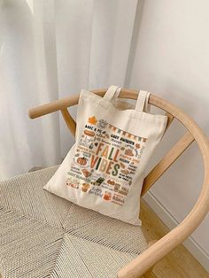 a white tote bag sitting on top of a wooden chair