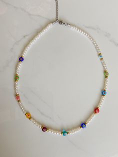 This gorgeous beaded necklace is made with a variety of millefiori beads, and pearl beads! Necklace measures 15 inches long! If you have any questions or concerns please feel free to message me and I'll try my best to get back to you ASAP Happy shopping!! Bohemian Pearl Necklace With Letter Beads, Bohemian Pearl Necklaces With Letter Beads, Pearl Necklace With Letter Beads And Round Beads, White Pearl Beaded Necklace With Spacer Beads, White Pearl Necklaces With Colorful Beads, Pearl Beaded Necklaces With Letter Beads, White Pearl Beaded Necklaces With Letter Beads, White Pearl Beaded Necklace With Letter Beads, White Pearl Necklaces With 8mm Beads