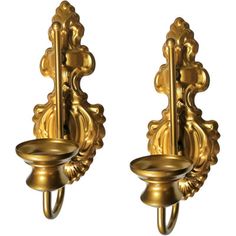 two golden wall sconces with handles on each side