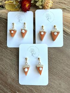 "Add a touch of autumn charm to your style with these adorable pumpkin pie polymer clay dangle earrings. Each pumpkin pie slice is meticulously sculpted to capture the essence of this seasonal delight. The warm orange hues and delicate crust texture bring a cozy and festive vibe to your jewelry collection. Whether you're a fall enthusiast or just love unique accessories, these earrings are perfect for expressing your love for pumpkin season. Wear them with your favorite sweater or the finishing touch to your Thanksgiving outfit. A must-have for fall lovers and food-inspired jewelry enthusiasts alike!   Each pair of earrings is meticulously handcrafted by me with love and attention to detail. I mix my own clay, cut, bake, sand, drill and assemble every piece so some slight variation may occ Fall Lovers, Pie Slice, Food Inspired, Clay Dangle Earrings, Knit Tights, Orange Hues, Pumpkin Season, Unique Accessories, Pumpkin Seasoning