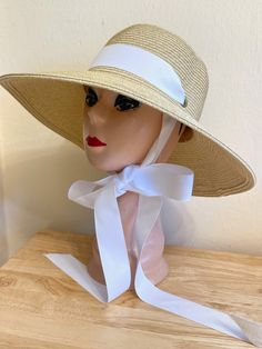 This 4 inch down turn brim Toyo straw hat is very durable and keeps the shape, great for travel. The hat has a removable white Grosgrain ribbon band and under chin tie. The hat will fit up to 22 7/8 inch head size with an inside sizing cord to adjust to your head size. You can easily remove the tie and use another ribbon or scarf to match your outfit. There are several ribbon options available, please see last photo for ribbon chart and put in the notes at check out if you would like a different White Toquilla Straw Hat For Garden Party, Classic Cream Straw Hat For Beach, Adjustable Straw Sun Hat For Garden Party, Cream Straw Hat Bands For Vacation, Cream Straw Hat Band For Vacation, White Toquilla Straw Hat Band For Beach, Upf 50+ Brimmed Straw Hat For Garden Party, Classic White Boater Hat For The Beach, Classic White Boater Hat For Beach