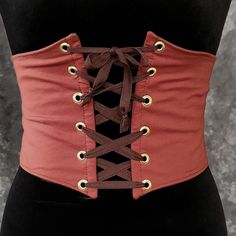 "This waist cincher is made in 100% Cotton in BURNT ORANGE. The perfect compliment to your Witch, Pirate, Renaissance, Medieval or other fantasy cosplay costume. It is lined with cotton duck and it has spring steel boning in the front for stability and to reinforce the grommets (this boning has some flex to it so it will move with you some as well). A very comfortable, yet sturdy piece.   Measure your waist as the smallest point (typically just about the belly button) and choose from the following sizes:  X-SMALL: Waist 25.5 - 28 inches (64 - 71 cm) SMALL: Waist 28 - 31 inches (71 - 79 cm)  MEDIUM: Waist: 30 - 33 inches (76 - 84 cm) LARGE: Waist: 32 - 35 inches (81 - 89 cm) X-LARGE: Waist: 34 - 37 inches (86.5 - 94 cm)  XXLARGE: Waist 36 - 39 inches (91.5 - 99 cm) ✿✿THIS PIECE IS MADE TO O Steampunk Corset Belt For Larp And Halloween, Steampunk Corset Belt For Cosplay, Gothic Corset Belt For Festivals, Steampunk Corset For Larp And Halloween, Brown Gothic Corset Belt For Cosplay, Steampunk Fitted Corset Belt For Festivals, Steampunk Corset Belt For Halloween, Steampunk Corset Belt For Halloween Festival, Punk Corset For Halloween Larp