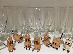 there are many wine glasses and mice on the table with beaded decorations around them