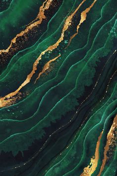 an aerial view of green, gold and black waves in the water with white dots on them