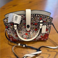 Off White Base, With Multi Colored Botanicals Print. Pebble Leather. Several Compartments. Included Adjustable And Detachable Shoulder Strap. Leather. New With Tags. Never Used. 7 1/2 (H) X 9 1/2" (L)X 3 1/2" (W) Hard To Find Print And Style. Very Cute. Coach Multicolor Top Handle Satchel, Multicolor Coach Top Handle Satchel, Hard To Find, Black Cream, Pebbled Leather, Coach Bags, Multi Colored, Satchel, Shoulder Strap