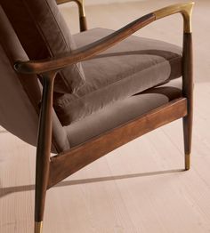 a brown chair sitting on top of a hard wood floor