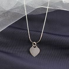 Personalized Heart Pendant Necklace The heart tag measures 17mm x 14mm, and it is made of sterling silver. The pendant is a great size for engraving initials. When you buy the pendant for yourself, you might want to have your own initials engraved but when you are buying it as a gift, you can have the initials of the recipient engraved on the tag instead.  This heart pendant is a nice gift for parents to give to their daughters, and it looks great with most silver chains that she might already have. It is small enough that it will not look too large on a smaller frame, and it will look great with many of the little outfits that she already has. She will love when you engrave her initials on it, and she can show it to her friends proudly. The heart tag pendant is something that she will be Minimalist Heart Pendant Necklace With Charms, Classic Sterling Silver Heart Pendant Necklace, Silver Engraved Initial Pendant Heart Necklace, Heart Cut Necklace With Heart Charm For Memorial, Personalized Silver Double Heart Charm Necklace, Classic Silver Necklace With Heart Charm, Memorial Heart Charm Open Heart Necklace, Classic Sterling Silver Double Heart Necklace, Memorial Heart Charm Necklace